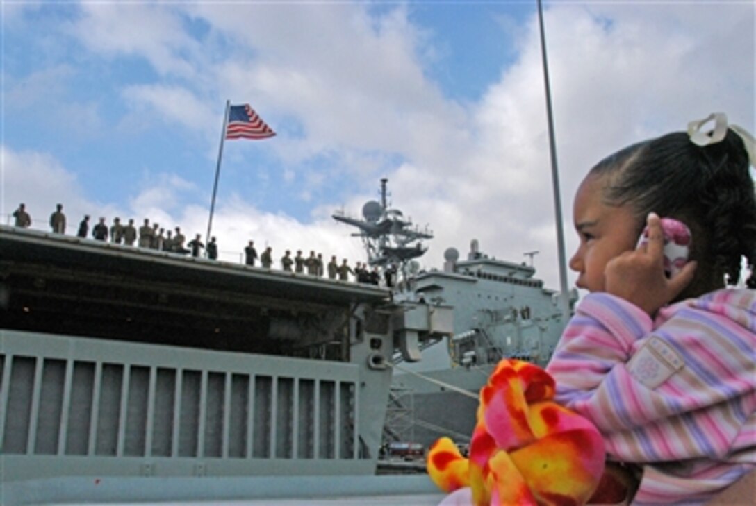 A little girl calls her father Feb. 15, 2006, moments before he departs with the USS Ogden from San Diego, Calif., for a scheduled six-month deployment. More than 6,000 servicemembers are deploying as part of Expeditionary Strike Group 3. 