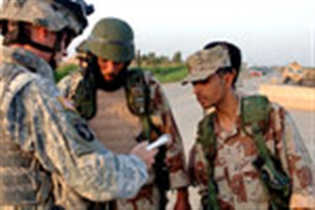 U.S. Army Sgt. Joshua Swainston, of Delta Company, 1st Battalion, 502nd Infantry Regiment, 101st Airborne Division, conducts training with Iraqi army soldiers at a traffic control point near Mahmudiyah, Iraq, April 13, 2006.