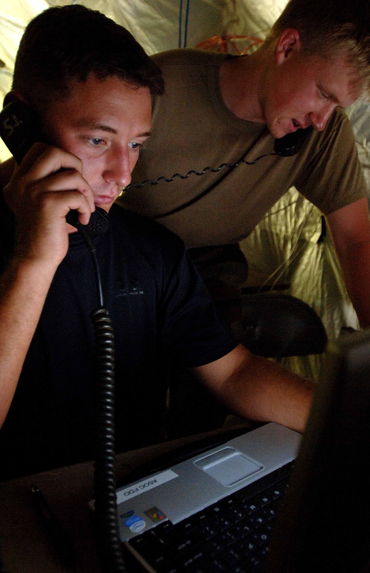 SSgt James Wiger (left) and A1C William Whitehead, 682d Air Support Operations Squadron, Tactical Air Control Party(TACP) members, process an air support request during Operation DYNAMIC WEASEL June 29, 2006 at McEntire Air National Guard Base, SC. Operation DYNAMIC WEASEL is a multi-aircraft exercise imitating combat operations currently taking place in Southeast Asia. (US Air Force Photo/Staff Sgt. Ashley Brokop)