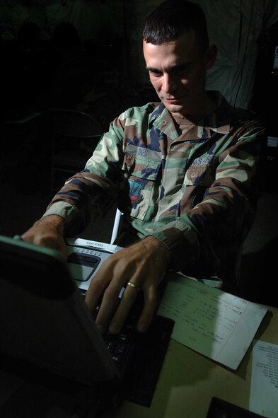 Staff Sgt. Christoper Jones, 682d Air Support Operations Squadron, programs a router for multi-cast video dissemination during Operation Dynamic Weasel June 29 at McEntire Air National Guard Base, SC. (U.S. Air Force photo/Staff Sgt. Ashley Brokop) 
