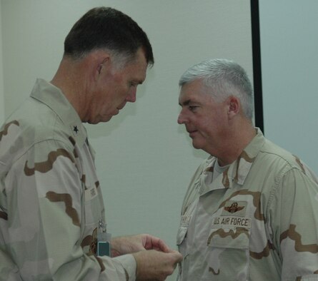 SOUTHWEST ASIA- Former 914th commander, Brig. Gen. WadeFarris, pins the rank of full colonel onto Col. Mark Murphy, 328AS, at a forward deployed location.