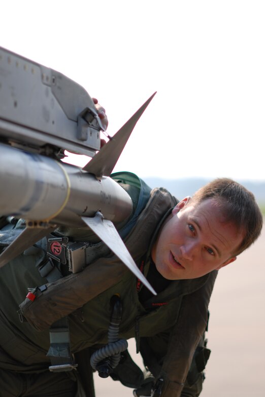 Capt. Ben Russo does a pre-flight check on his F-16 Fighting Falcon before a mission supporting Operation Dynamic Weasel on Thursday, June 29, at Shaw Air Force Base, S.C. The exercise features various aircraft imitating combat operations in Southwest Asia. Captain Russo is assigned to the 77th Fighter Squadron. (U.S. Air Force photo/Tech. Sgt. James Arrowood)
