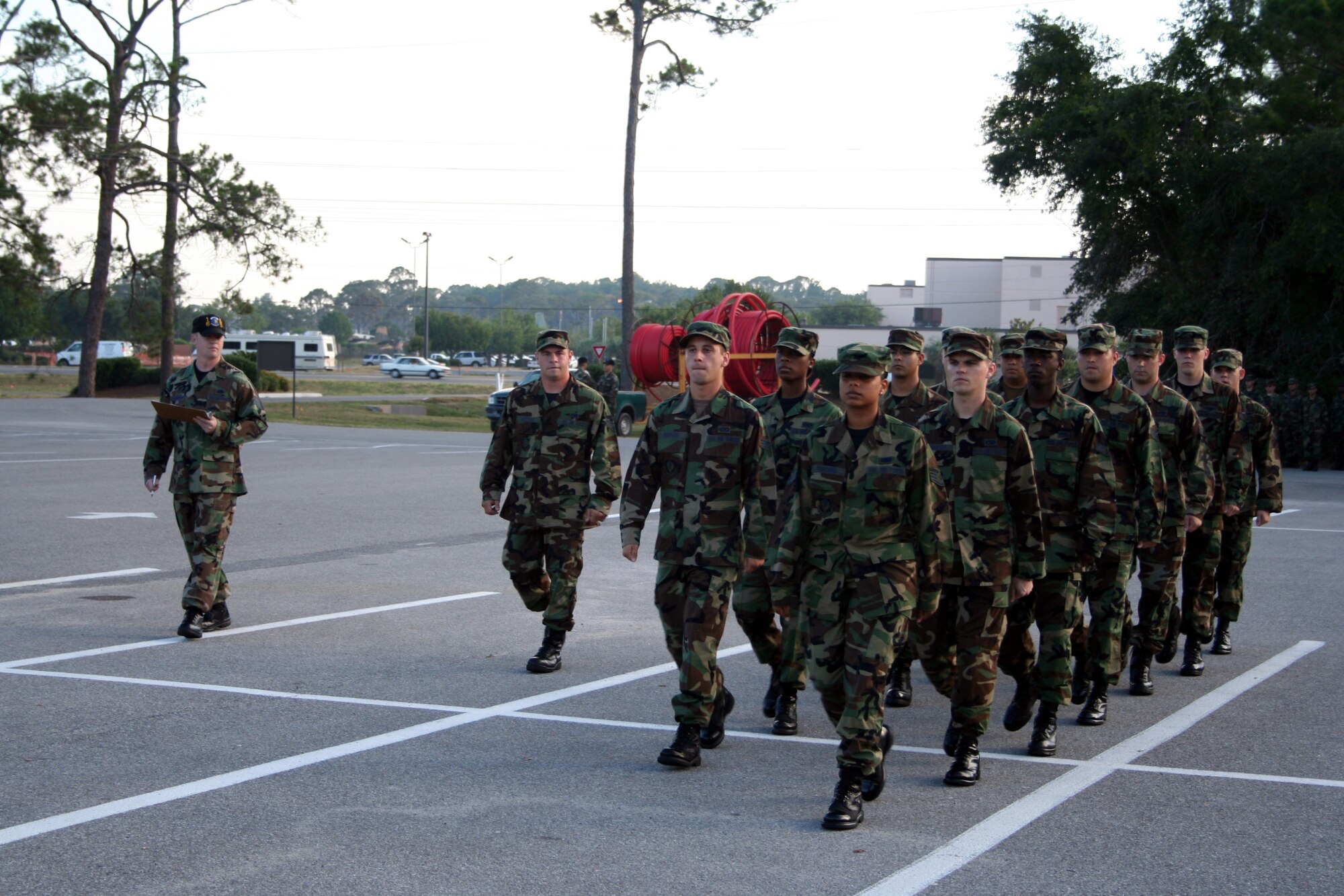 Senior Airman Wesley HUffman, far left in formation, 716th Maintenance Squadron, leads his ALS flight in drill formation as Tech. Sgt. George Anderson, left, 16th Equipment Maintenance Squadron, evaluates his performance. ( Photograph by Dylan Laurie)