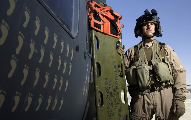Tech. Sgt. Mark De Corte is an aerospace evacuation technician with the 33rd Expeditionary Rescue Squadron in Kandahar, Afghanistan. The tan footprints on the HH-60 Pavehawk helicopter represent each of the saves the squadron has made. (U.S. Air Force photo/Senior Airman Brian Ferguson) 