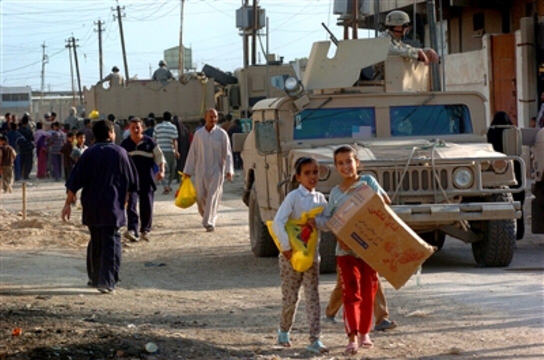 Children in Kamaliya, Iraq, walk off with a humanitarian assistance bag given to them by U.S. Army soldiers April 28, 2006. Soldiers from Delta Company, 3rd Battalion, 67th Armored Regiment, 4th Brigade, 101st Airborne Division, distributed donated supplies to the villagers.