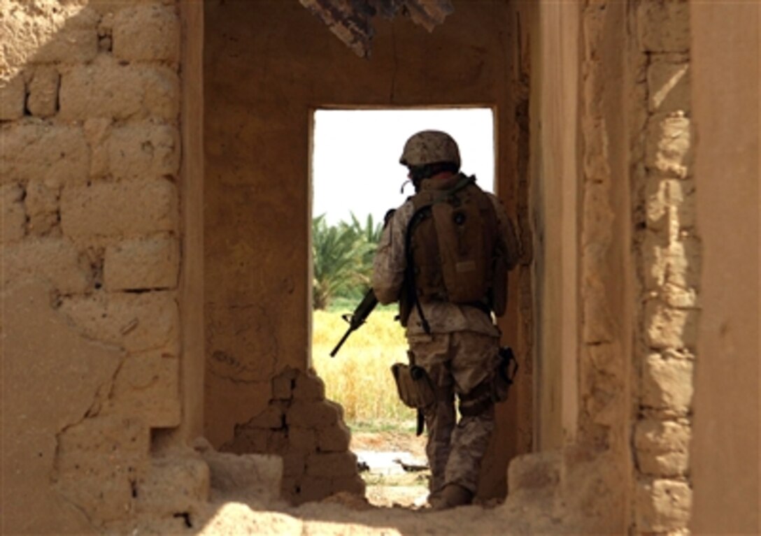 U.S. Marine Sgt. Jonathon D. Lewis clears an abandoned house during a patrol near the town of Al Ish, Iraq, April 29, 2006. Lewis is with Weapons Company, 1st Battalion, 7th Marines Regiment.