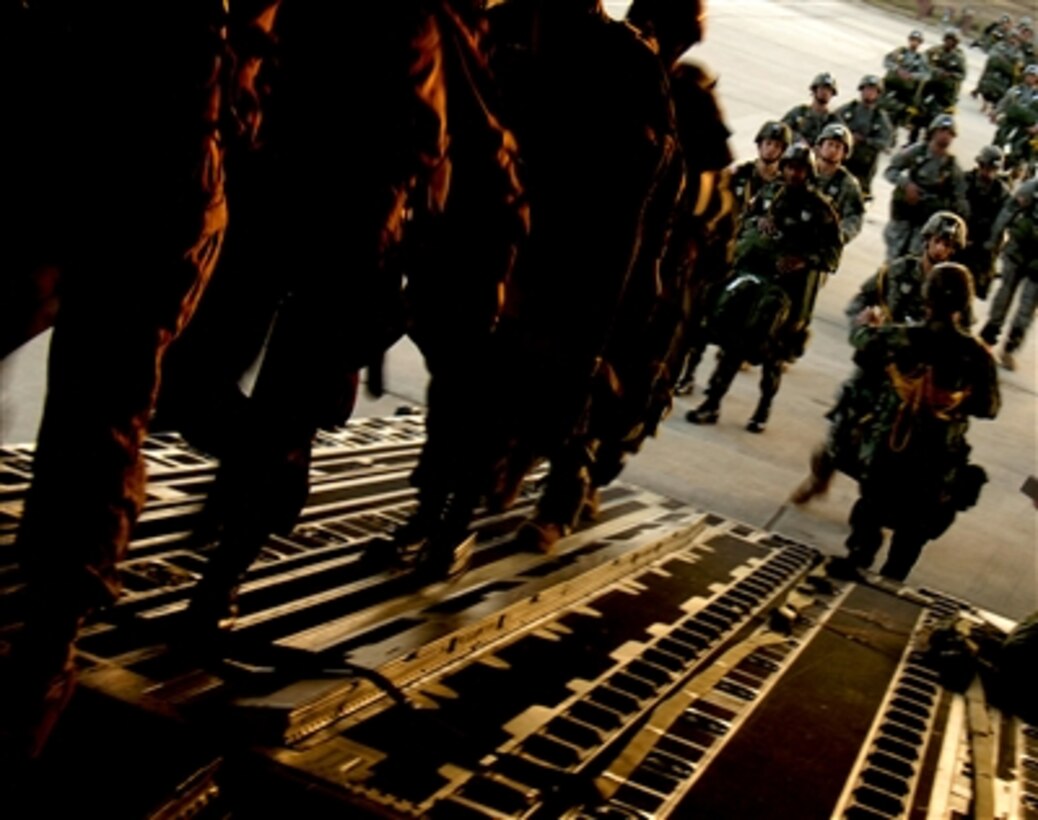 U.S. Army soldiers, assigned to the 82nd Airborne Division, Fort Bragg, N.C., board a C-17 Globemaster III aircraft on Pope Air Force Base, N.C., Jan. 25, 2006. The soldiers will airdrop into Fort Bragg as part of a joint forcible entry exercise.