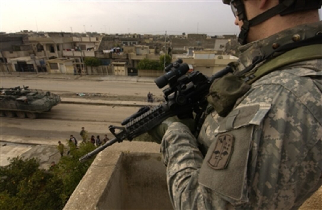 U.S. Army Spc. Nick Merrick provides overwatch security during a patrol in Mosul, Iraq, Feb. 5, 2006. Merrick is with the 2nd Battalion, 1st Infantry Regiment, 172nd Stryker Brigade.