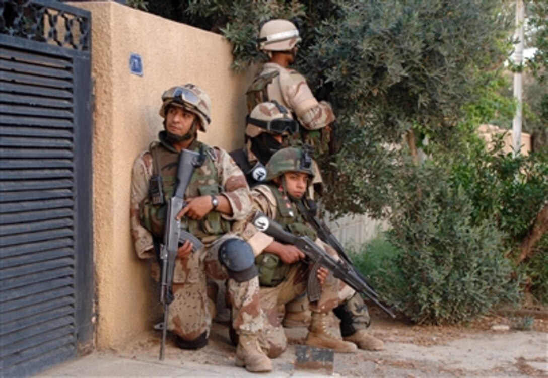 A team of Iraqi soldiers prepare to enter a home for a routine search in Ameriyah, Iraq, April 27, 2006. Soldiers from the 4th Iraqi Army Brigade and Delta Company, 1st Battalion, 87th Infantry conducted a joint patrol to search for illegal weapons and to give local people a feeling of security.