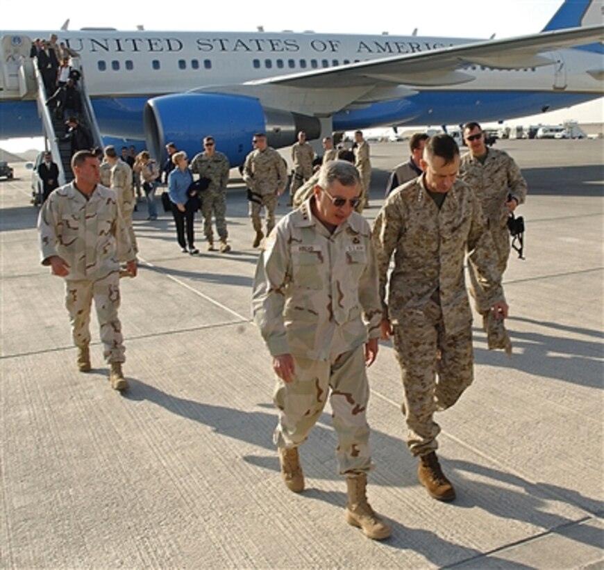 U.S. Army Gen. John Abizaid, commander, U.S. Central Command, escorts U.S. Marine Corps Gen. Peter Pace, chairman of the Joint Chiefs of Staff, from his plane after arriving in Southwest Asia, Dec. 28, 2005. 