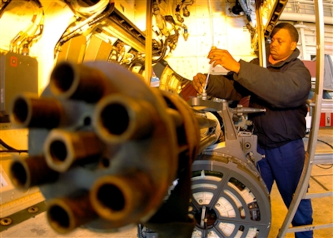 U.S. Navy Petty Officer 2nd Class Rashon McCall, assigned to the Diamondbacks of Strike Fighter Squadron 102, connects a hoisting cable on a 20mm Vulcan Gatling gun at Atsugi, Japan, Dec. 27, 2005. The squadron recently returned to Japan after a regularly scheduled deployment aboard the conventionally powered aircraft carrier USS Kitty Hawk. 