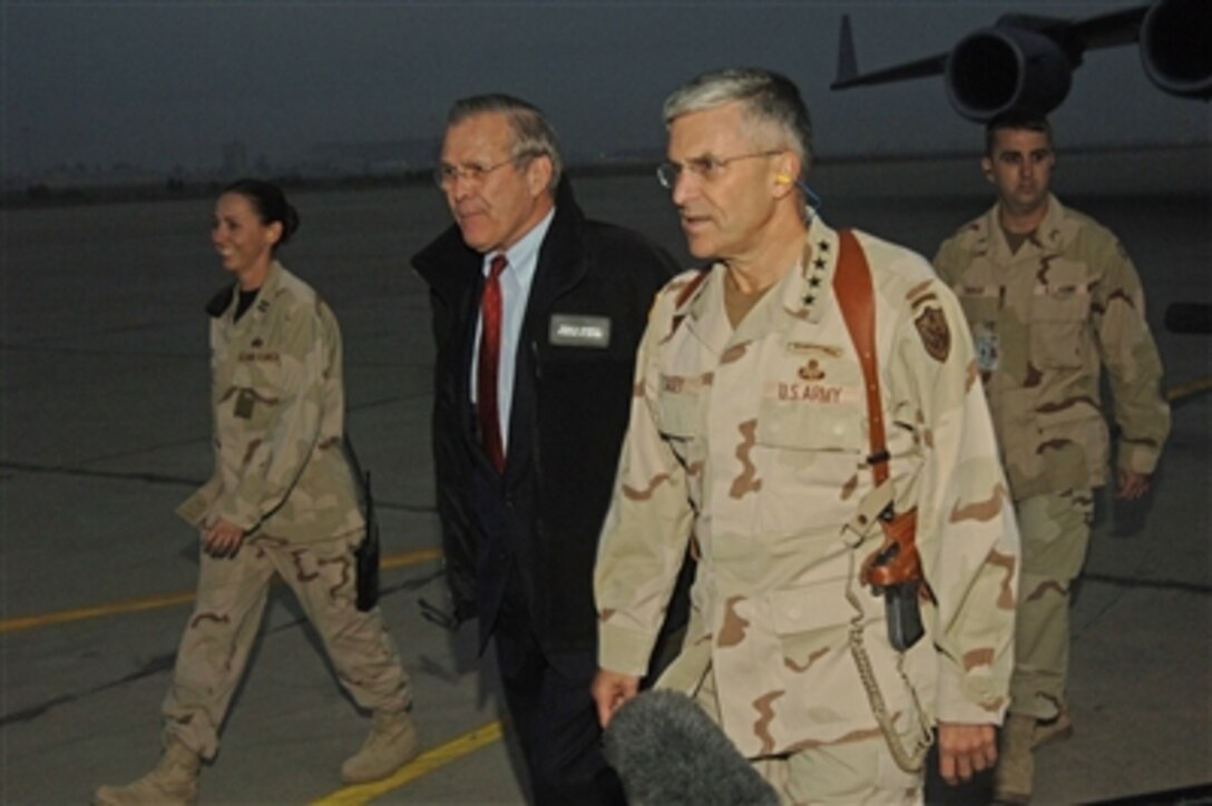 U.S. Defense Secretary Donald H. Rumsfeld arrives in Baghdad, Iraq on Dec. 22, 2005 and is greeted by Gen. George Casey Jr., Commanding General Multi-National Force Iraq. 