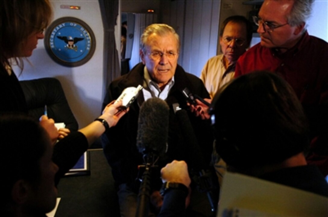 Defense Secretary Donald H. Rumsfeld responds to a question from the media while traveling to Pakistan Dec. 20, 2005. Rumsfeld will visit the areas damaged by the Oct. 8, 2005, earthquake and talk with U.S. personnel working to aid the survivors. 
