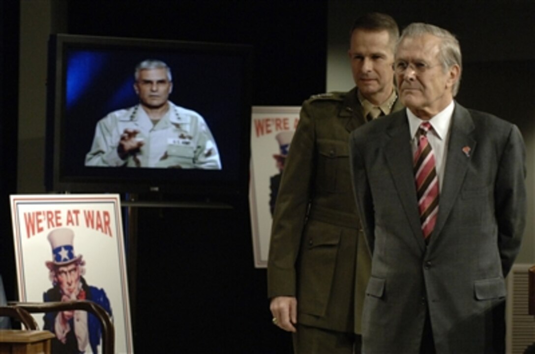 Defense Secretary Donald H. Rumsfeld and Chairman of the Joint Chiefs of Staff U.S. Marine Corps Gen. Peter Pace listen as Commander of Multinational Force-Iraq U.S. Army Gen. George W. Casey Jr., describes the success of the Iraqi elections via satellite feed. Rumsfeld hosted the Pentagon Town Hall meeting on Dec. 15, 2005. 