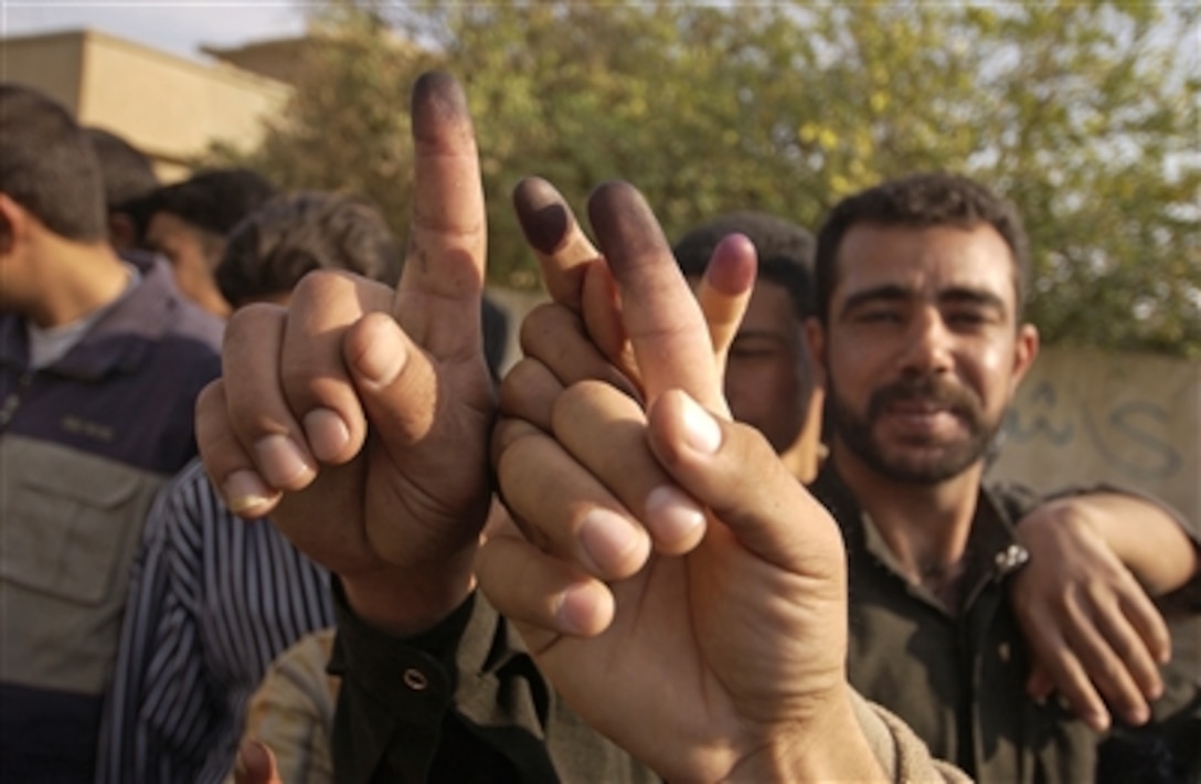 A group of Iraqi men show their inked fingers after voting in Hayji, Iraq, Dec. 15, 2005. Iraqi citizens are electing their first permanent parliamentary government, which will lead the new democracy for the next four years.  
