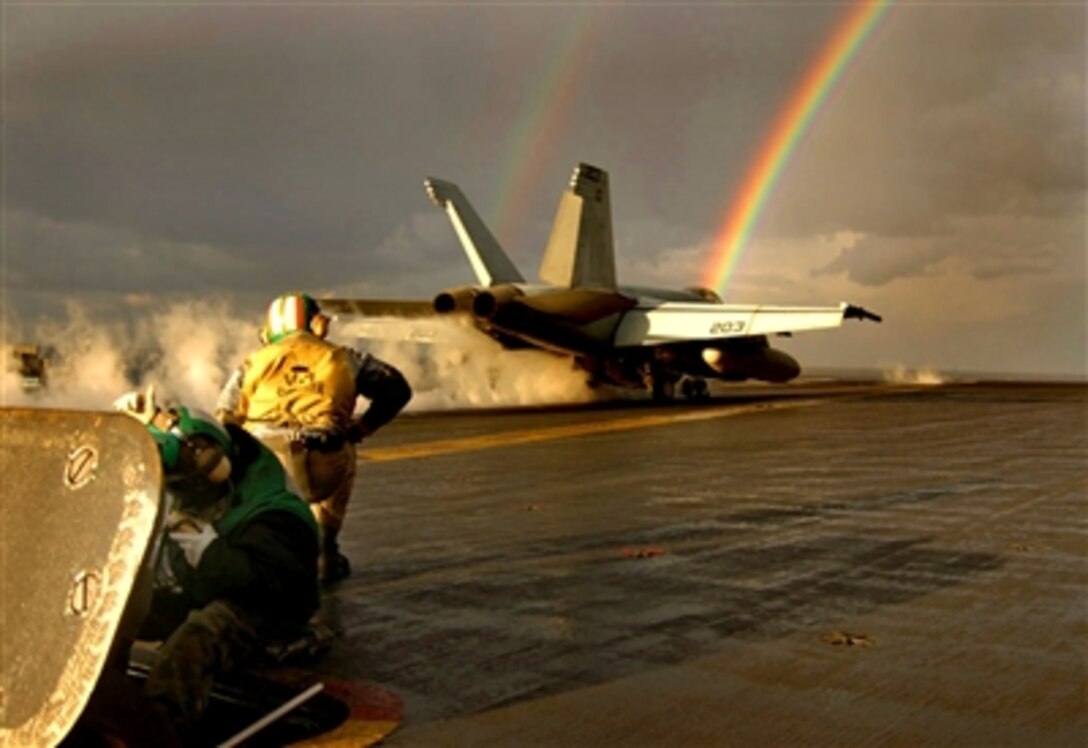 An F/A-18E Super Hornet of Strike Fighter Squadron 27 launches off the flight deck of USS Kitty Hawk and through a rainbow during an afternoon shower, Dec. 7, 2005. The Kitty Hawk is the U.S. Navy's only forward deployed aircraft carrier, operating out of Yokosuka, Japan. 