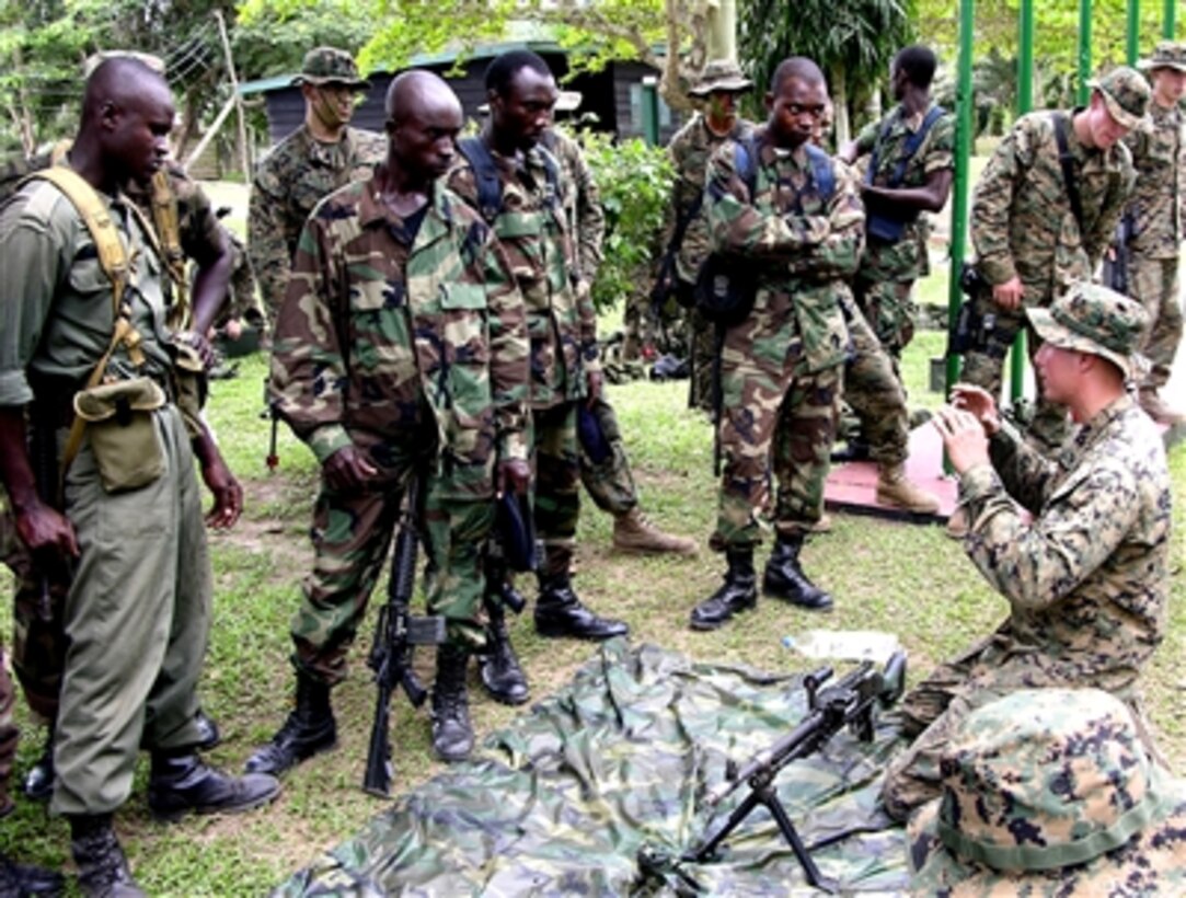 U.S. Marine Cpl. Richard Hazenburg of 2nd Platoon, Charlie Company, 1st Battalion, 8th Marine Regiment, instructs Ghanaian soldiers on the M-240G medium machinegun at a jungle warfare school at Achiase, Ghana, Oct. 18, 2005, during West African Training Cruise '06.