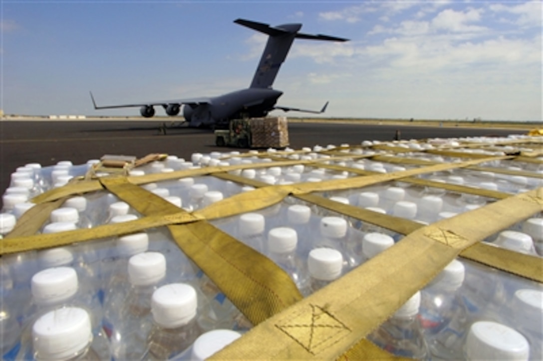 Pallets of bottled water are unloaded from a C-17 Globemaster at Homestead Air Reserve Station, Fla., Oct. 28, 2005. The C-17, deployed from the 172nd Airlift Wing, Jackson Air National Guard Base, Miss., delivered 18 pallets equaling 140,000 pounds of food, water and juice in support of Hurricane Wilma relief efforts.