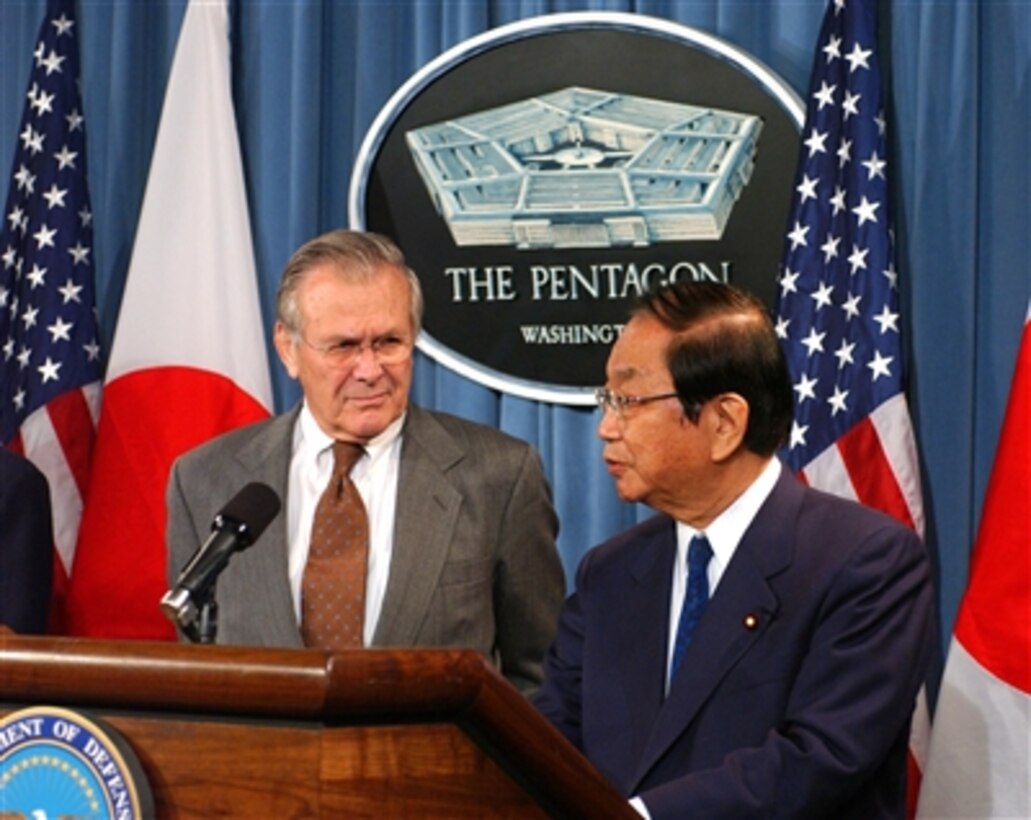 U.S. Defense Secretary Donald H. Rumsfeld listens to Japanese Defense Minister Yoshinori Ohno during a press briefing in the Pentagon, Oct. 29, 2005. Rumsfeld and Ohno discussed U.S.-Japan Alliance Transformation and Realignment.