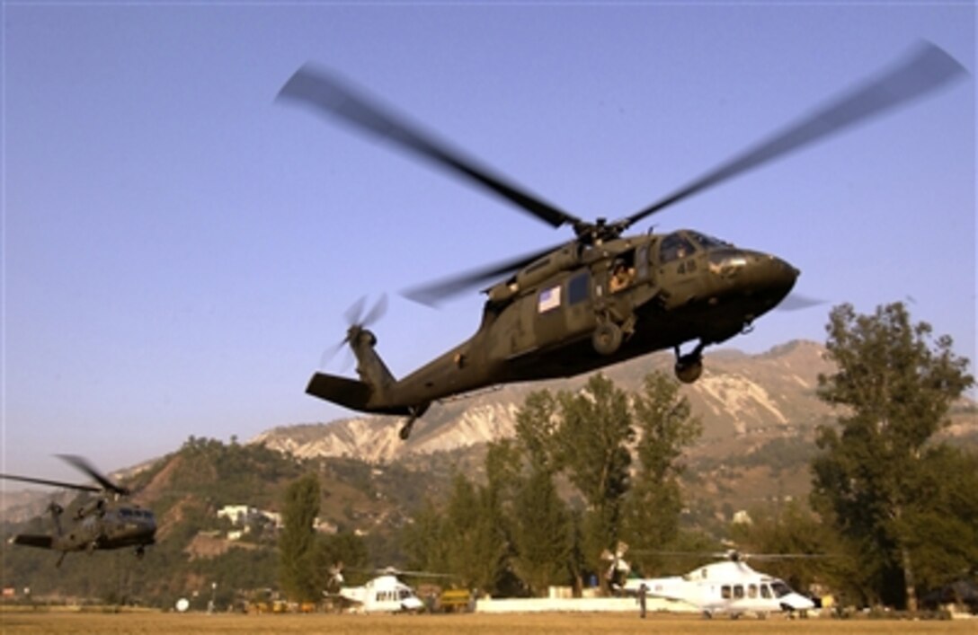 pair of U.S Army UH-60 Black Hawk helicopters lift off with casualties from Muzaffarabad to transport to Islamabad, Pakistan, Oct. 23, 2005.