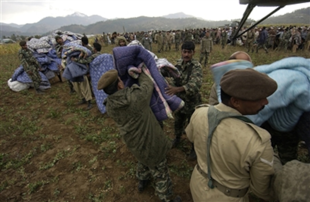 Pakistani soldiers unload disaster relief supplies from a U.S. Navy MH-53E "Sea Dragon" helicopter in Balakot, Pakistan, Oct. 15, 2005. The Defense Department is participating in the multinational effort to provide humanitarian assistance and support to Pakistan and parts of India and Afghanistan following a devastating earthquake.
