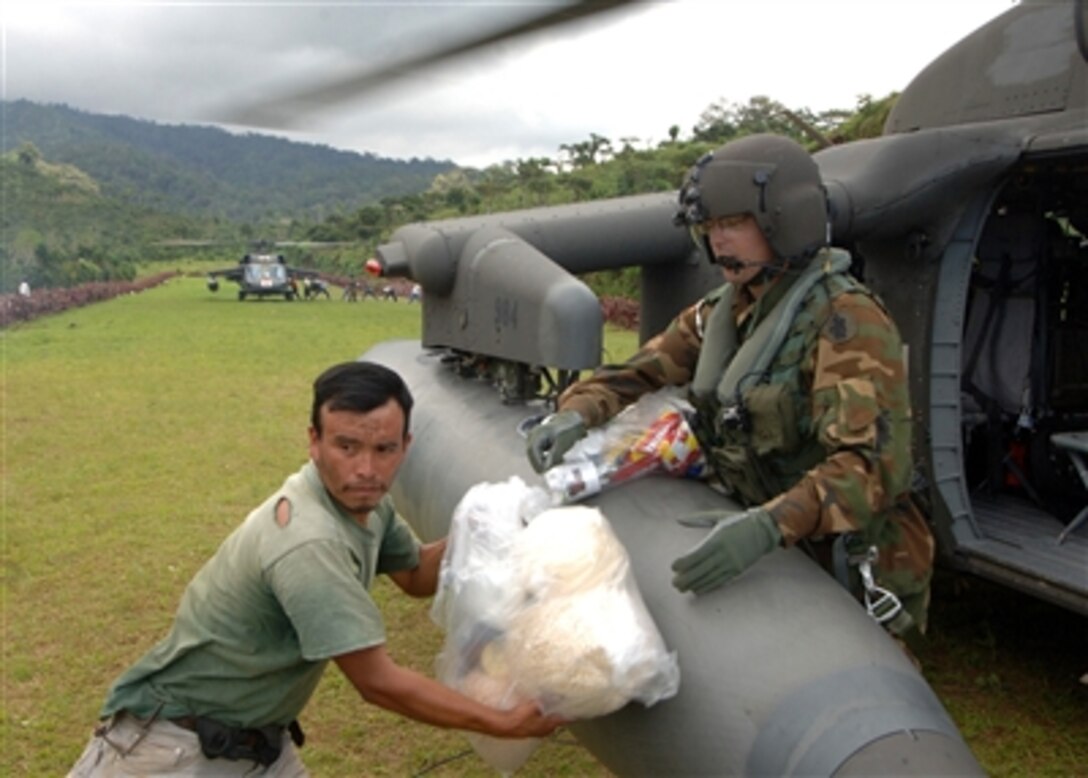 U.S. Army Spc. Ryan Becker unloads food, water, and medicine from a Black Hawk helicopter during relief efforts from Hurricane Stan in Guatemala, Oct. 16, 2005. U.S. military personnel with the U.S. Southern Command Joint Task Force Bravo continue to provide assistance to the government and the people of Guatemala as part of an ongoing disaster relief effort in the wake of Hurricane Stan.