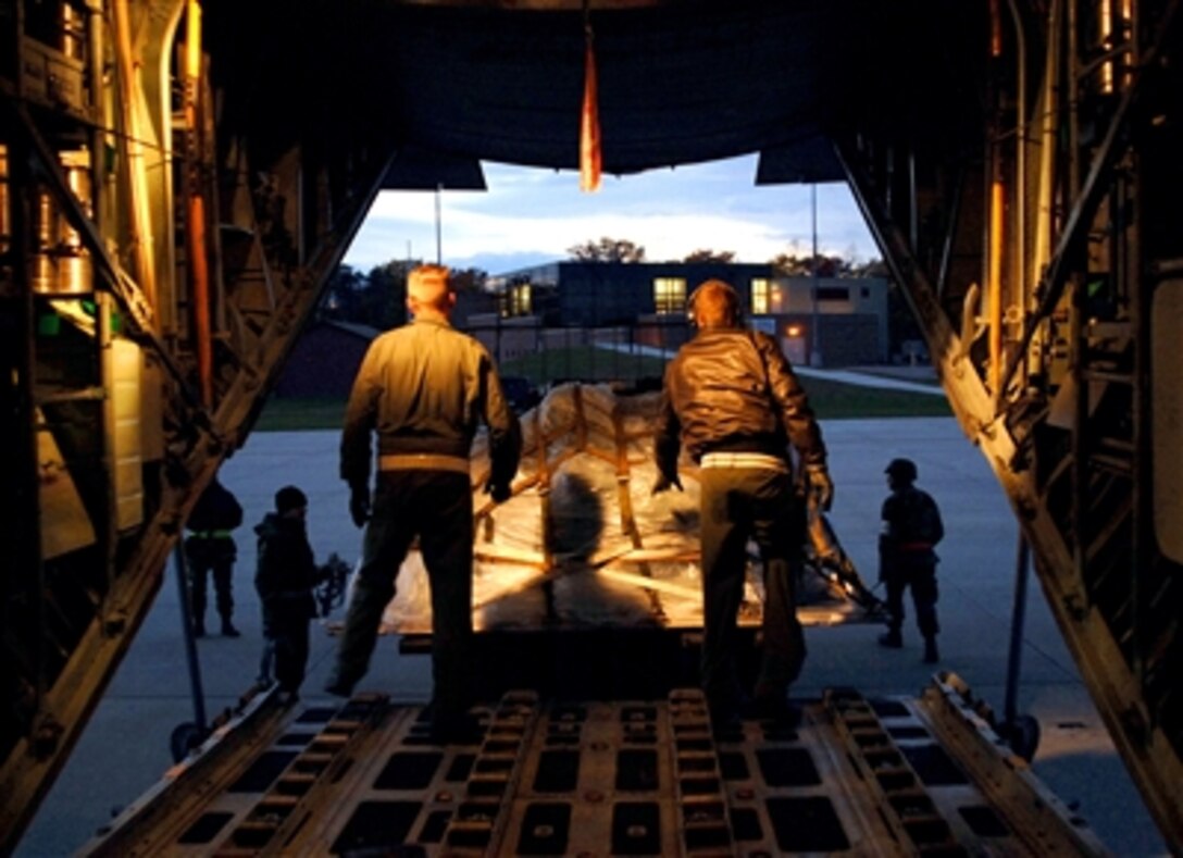 The loadmaster and crewchief of a C-130, assigned to the 146th Tactical Airlift Wing, California Air National Guard, push the final pallet of cargo off the aircraft and onto a forklift in Alpena, Mich., Nov. 1, 2005. The wing left their home station in Port Hueneme, Calif. to participate in an a joint exercise with the 375th Airlift Wing, an active duty unit from Scott Air Force Base, Mo. 