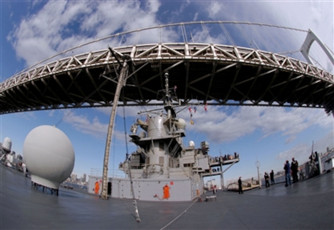 Crew members and guests watch as the USS Blue Ridge steams under Tokyo's Rainbow Bridge, Nov. 19, 2005. Sailors took the opportunity to invite more than 300 of their friends and family members for a day cruise to Tokyo. Blue Ridge is the 7th Fleet command ship and is permanently forward deployed to Yokosuka, Japan. 