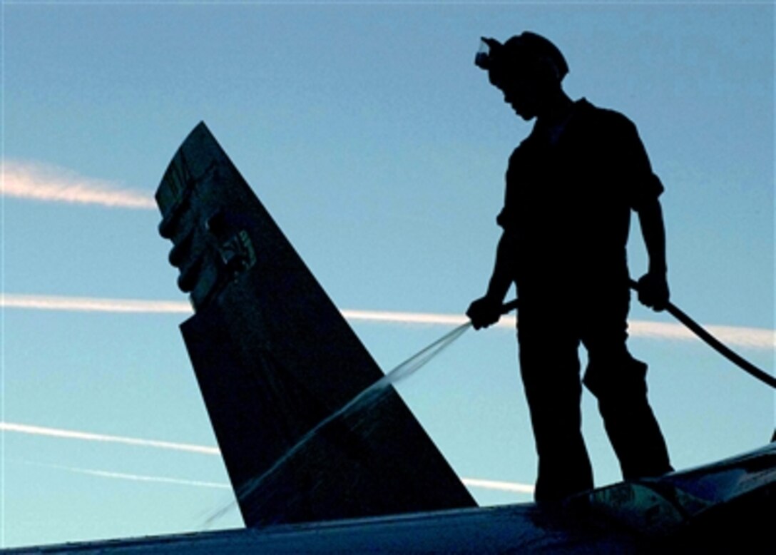 U.S. Navy Petty Officer 1st Class Wonderful Parker signals to the catapult officer that a jet is ready to launch from the flight deck of the nuclear-powered aircraft carrier USS Enterprise in the Atlantic Ocean, Nov. 20, 2005.