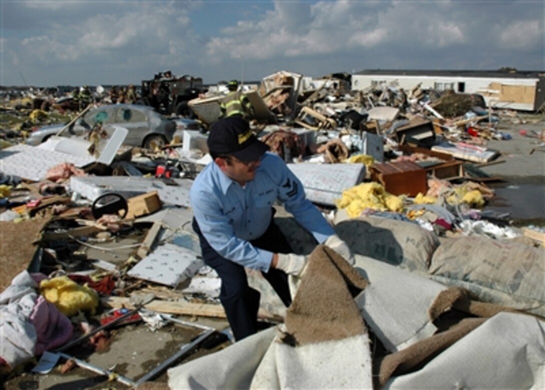 U.S. Navy Petty Officer 2nd Class Billy Marcum assists with search and rescue efforts Nov. 6, 2005, in Evansville, Ind., after a tornado destroyed a mobile home park early that morning. Marcum is assigned to Navy Reserve Command, Navy Training Center Great Lakes, Detachment 1327. 
