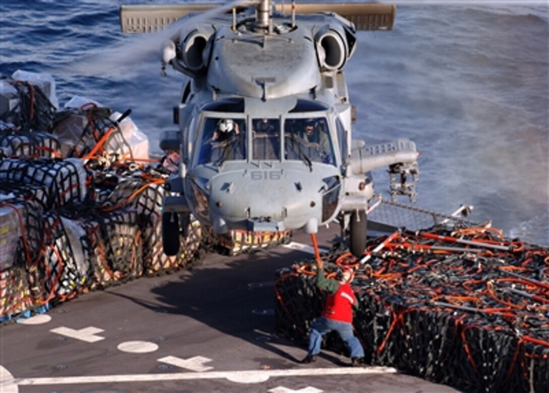 Naval aviators aboard an HH-60H Seahawk helicopter prepare to receive supplies from sailors on the Military Sealift Command fast combat support ship USNS Laramie in the Atlantic Ocean, Nov. 15, 2005.