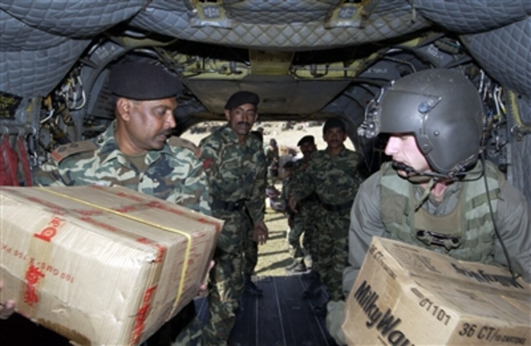 U.S. Army Spc. Thaddeus Spencer helps Pakistani servicemembers unload humanitarian relief supplies from a CH-47D Chinook helicopter in Darband, Pakistan, Nov. 16, 2005. The U.S. government is participating in a multinational humanitarian assistance and support effort led by the Pakistani government to bring aid to victims of the devastating earthquake that struck the region Oct. 8, 2005.