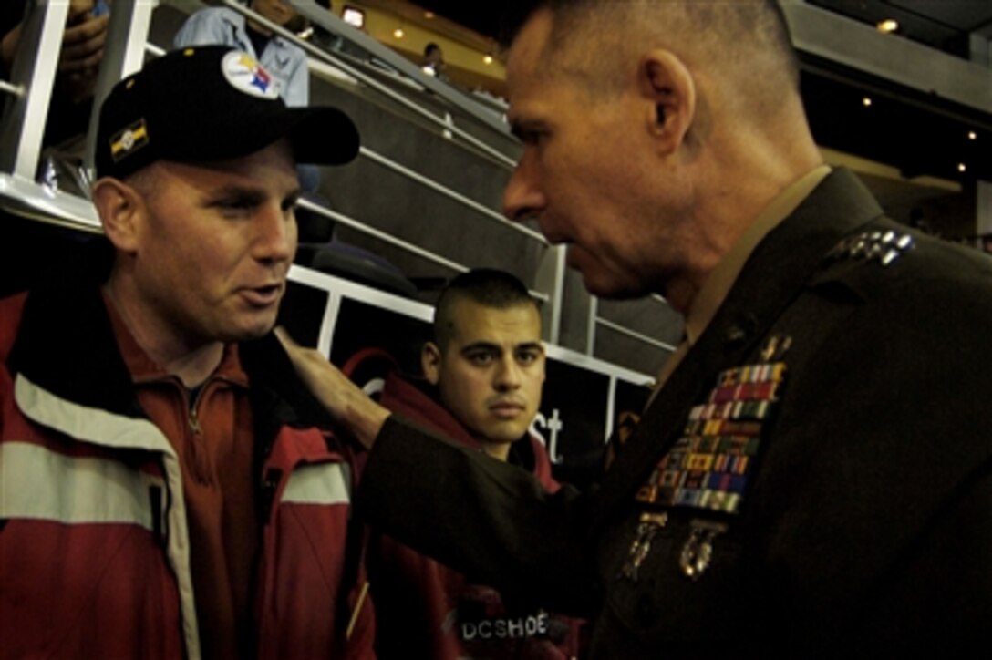Chairman of the Joint Chiefs of Staff Marine Gen. Peter Pace talks with a Walter Reed Army Medical Center patient between periods of the Washington Capitals and St. Louis Blues hockey game in Washington, D.C., Jan. 19, 2006. Pace attended the game as part of the Capitals' fourth "Salute to the Military Night" which is dedicated to honoring the servicemen and women who serve in the defense of the United States of America. 
