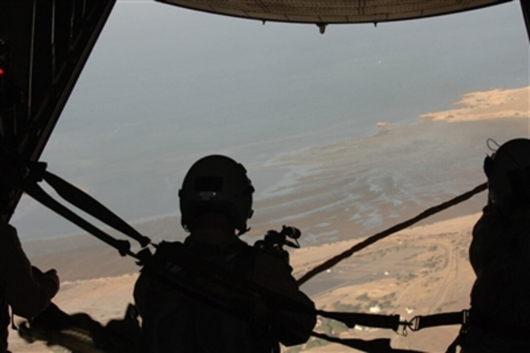 U.S. Air Force Tech. Sgt. James Carney, a combat videographer from the 1st Combat Camera Squadron, Charleston Air Force Base, S.C., documents a training airdrop exercise from a U.S. Air Force C-130 Hercules over Djibouti, Africa, Dec. 31, 2005.