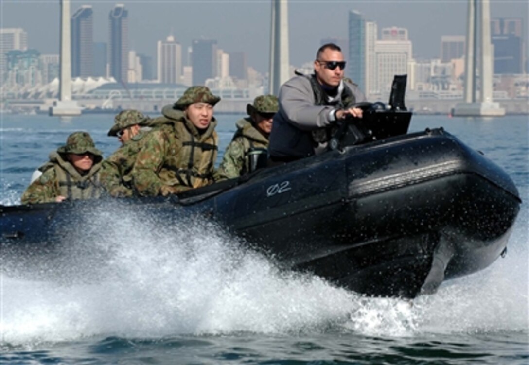 U.S. Marine Corps Staff Sgt. David Cleaves drives a Combat Inflatable Craft carrying Japanese soldiers during Exercise "Iron Fist" near Naval Amphibious Base Coronado, Calif., Jan. 12, 2006. Cleaves is an instructor assigned to the Expeditionary Warfare Training Group - Pacific. The exercise is designed to help Japanese forces train on amphibious assault operations, water survival, and boat operations.