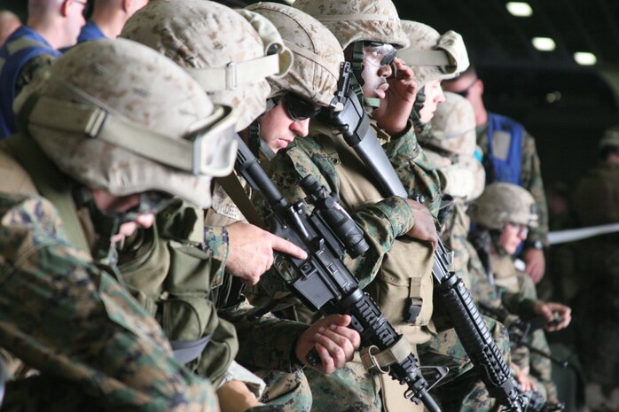Marines from weapons company Battalion Landing Team 1st Battalion 8th Marines, lock and load and conduct a live fire exercise on board the USS Iwo Jima on July 1, 2006. The BLT is the ground combat element of the 24th Marine Expeditionary Unit, which is based out of Camp Lejuene North Carolina. The purpose of the live fire exercise is to hone in the Marines shooting skills with a full combat load. (U.S. Marine Corps Photo by Lance Corporal Joshua Lujan)