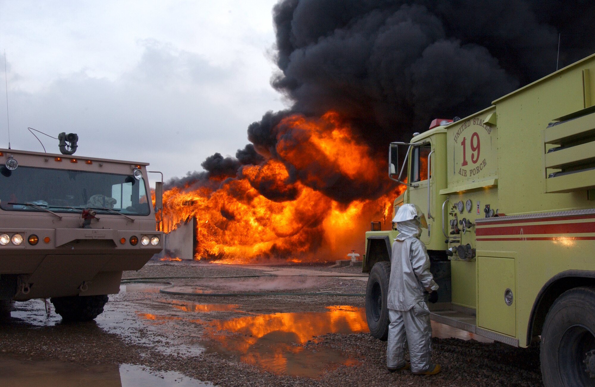 Four fire trucks and 24 firefighters are on hand for a live-fire training exercise at Balad Air Base, Iraq, Thursday, Feb. 16, 2006. (U.S. Air Force photo/Tech. Sgt. Steve Horton)

          