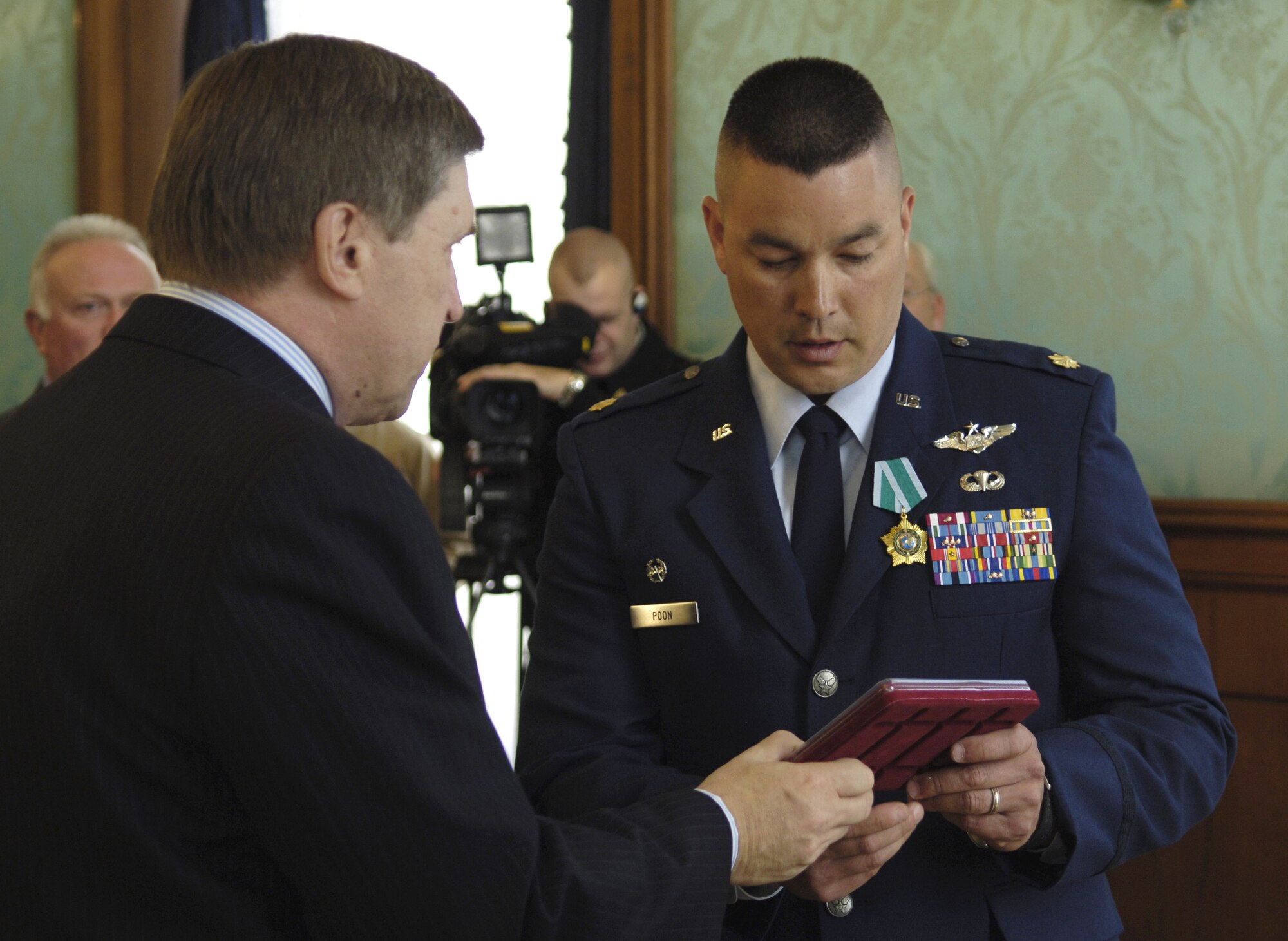 Russian ambassador Yuri Ushakov presents Maj. Patrick Poon with the highest honor awarded to non-Russian citizens, the Order of Friendship Medal, at the Russian Embassy in Washington, D.C., Tuesday, Feb. 28, 2006. Major Poon and Navy Lt. Cmdr. Steven Smith received the medals for their actions associated with the rescue of a Russian submarine crew Aug. 7. (Department of Defense photo/Staff Sgt. D. Myles Cullen)

