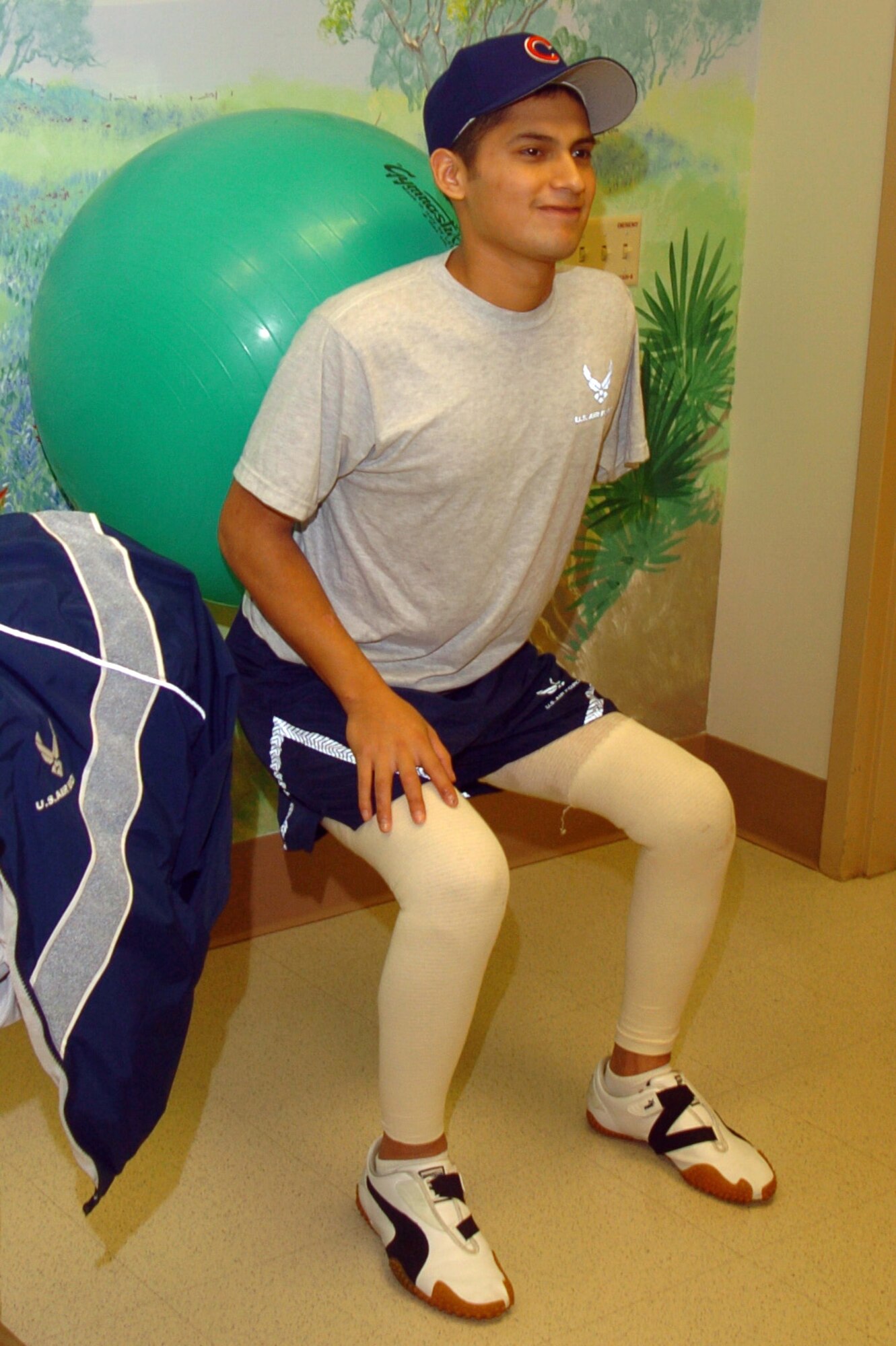 Senior Airman Dan Acosta uses an exercise ball to help him complete squats Thursday, Feb. 23, 2006, at the burn rehabilitation center at Brooke Army Medical Center in San Antonio. (U.S. Air Force photo/Steve White) 