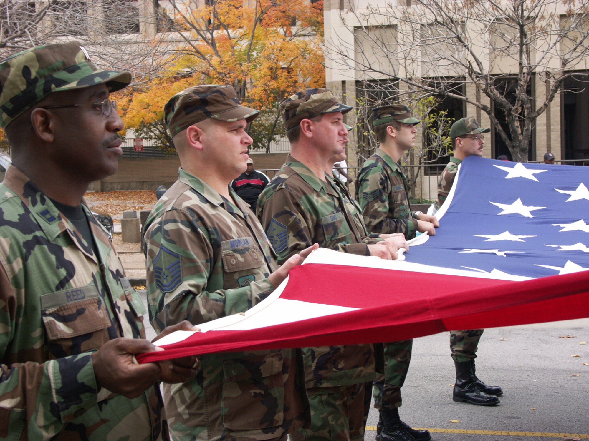 Members of the Air Force Reserve Command's 932nd Airlift Wing at Scott AFB, Ill., carry an oversized flag during a Veteran's Day parade.