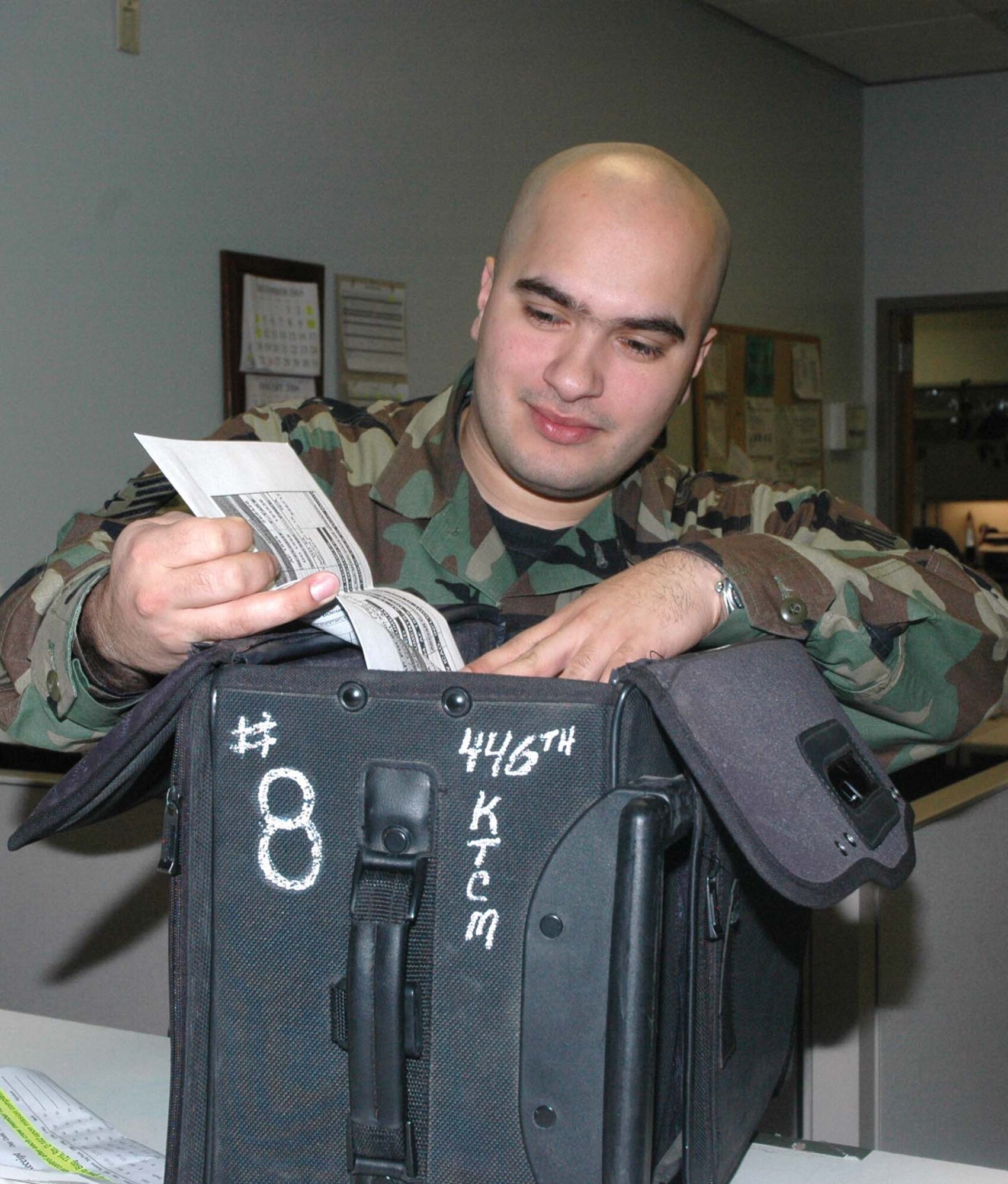 MCCHORD AIR FORCE BASE, Wash., -- Staff Sgt. Robert Jimenez, 446th Operations Support Flight, digs through a mission kit.  Maintaining the kits is just one of the many responsibilities for the Reservists who work at mission control.