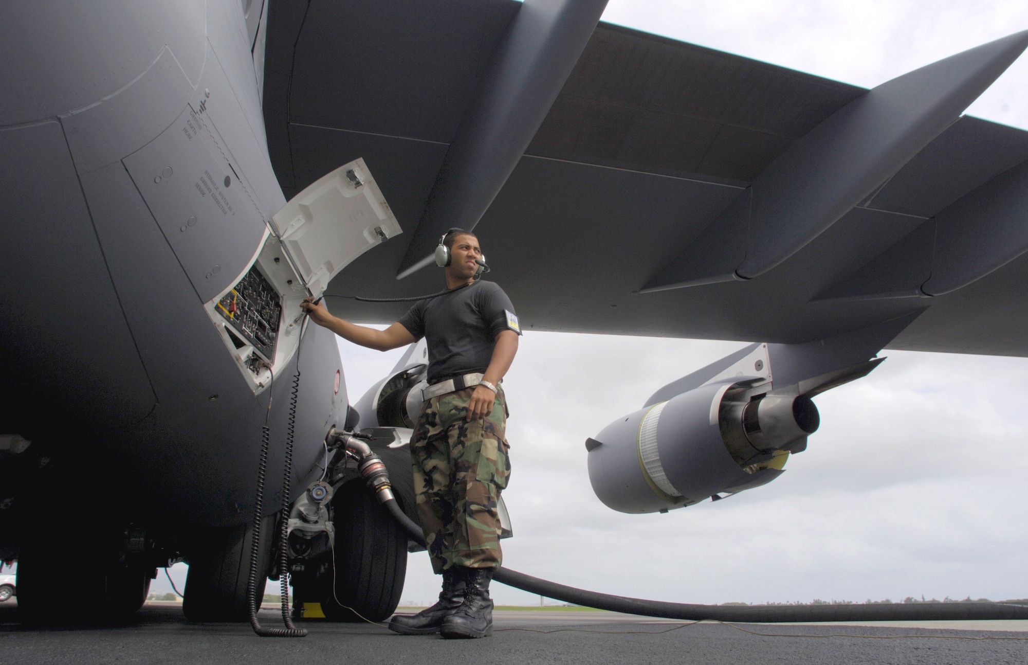 Airman 1st Class Justin Soileau-Gobert refuels a C-17 Globemaster III at Hickam Air Force Base, Hawaii, Tuesday, Feb. 28, 2006.  Airman Soileau-Gobert is a crew chief with the 15th Maintenance Group, which is a combined active duty and Air National Guard maintenance group. (U.S. Air Force photo/Tech. Sgt. Shane A. Cuomo)