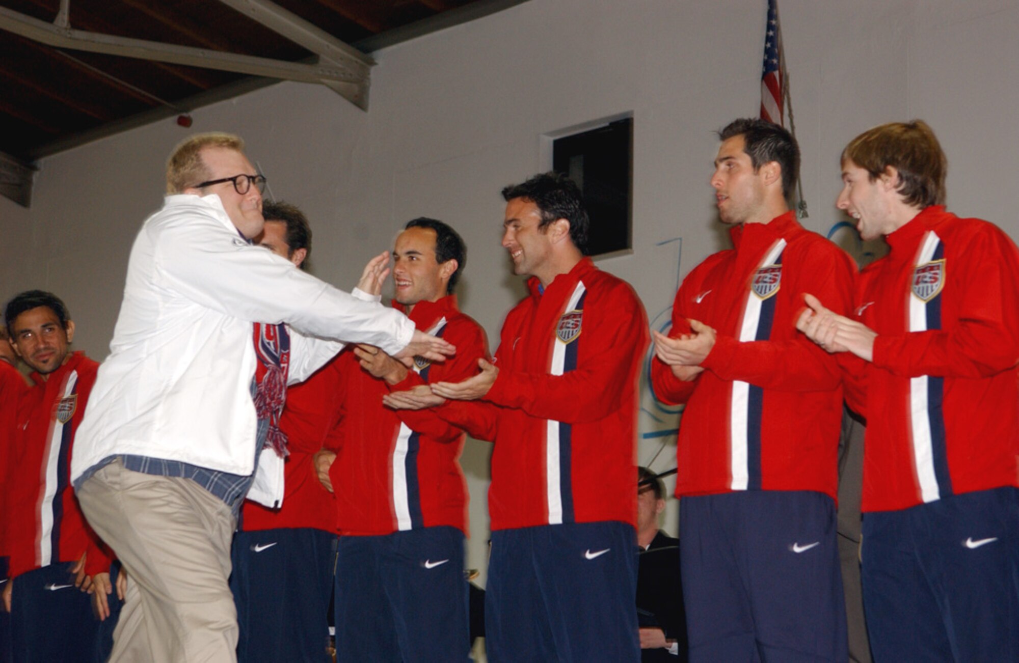 Drew Carey greets the U.S. Men's National Soccer Team at a pep rally Tuesday, Feb. 28, 2006, at Ramstein Air Base, Germany. The team is playing against Poland March 1 in Kaiserslautern. Mr. Carey came as a surprise guest to the rally to support the team and meet with fans. (U.S. Air Force photo/Airman 1st Class Erin Peterson)