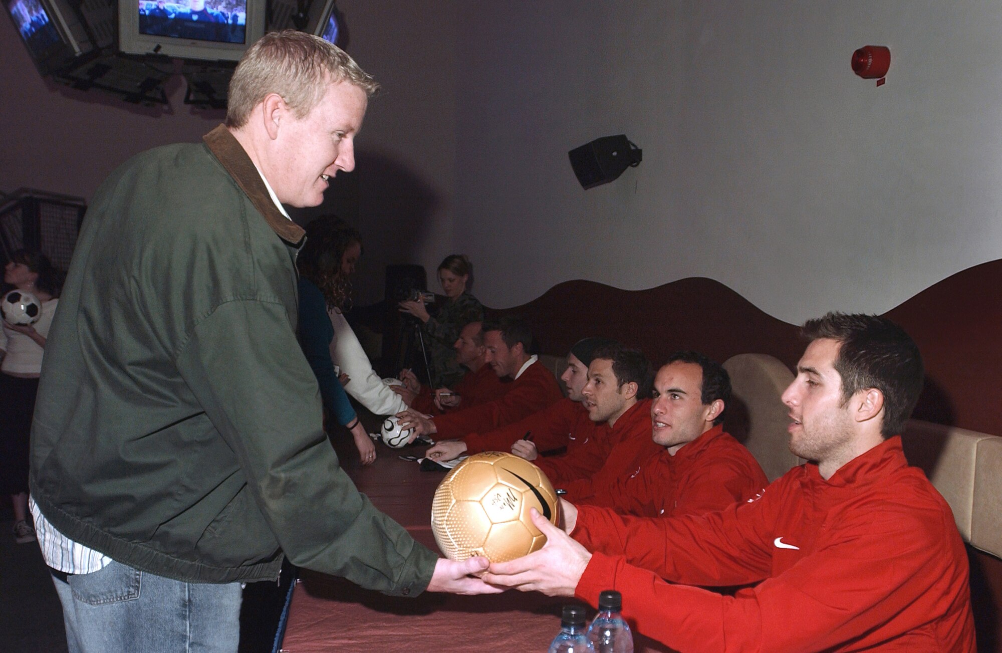 Staff Sgt. Larry Way gets an autograph from U.S. Men's National Soccer Team defender Carlos Bocanegra at Ramstein Air Base, Germany, Monday, Feb. 27, 2006. The team also held a pep rally for fans Feb. 28. The team is playing against Poland in Kaiserslautern March 1. Sergeant Way is assigned to the 435th Vehicle Maintenance Squadron. (U.S. Air Force photo/Senior Airman Christopher Willis)