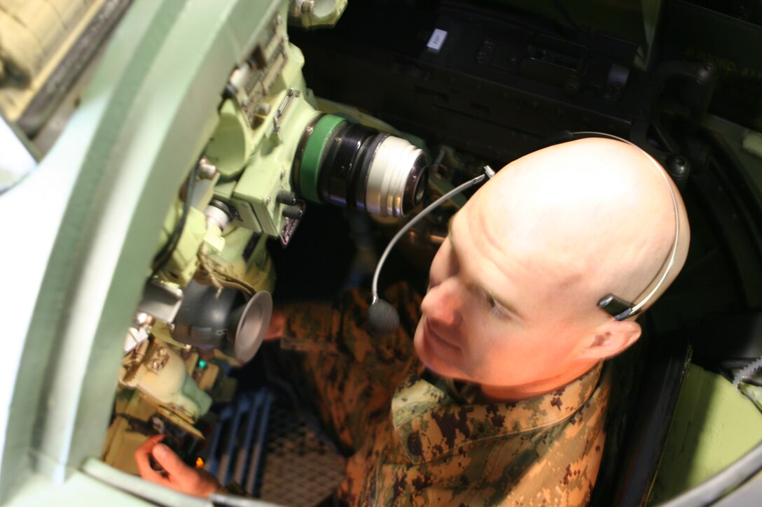 Staff Sgt. Michael P. Connors, battalion gunner, 2nd Assault Amphibian battalion, sits inside the amphibious assault vehicle turret trainer during a mock training exercise Feb. 28. Connors, along with other Marines were attending a three day trainer course to become familiarized with the newly installed virtual simulator. The $2.2 million turret trainer project was first tested in Camp Lejeune and an approved model is now being installed on other Marine Corps Installations.
