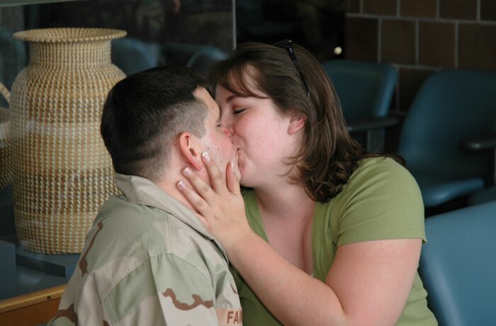 Staff Sgt. Jeff Fairchild, an Air Force reservist assigned to the 81st Aerial Port Squadron, Charleston AFB, S.C., gives a good-bye kiss to his wife at the Charleston International Airport, as he waits to leave for an extended deployment.  (Photo by 1st Lt. Wayne Capps, USAFR)