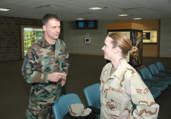 Senior Airman Christine Haltiwanger, an Air Force reservist assigned to the 81st Aerial Port Squadron, Charleston AFB, S.C., hears a few words of wisdom by her first sergeant, Senior Master Sgt. Mark Barber, as she waits to leave for an extended deployment at the Charleston International Airport.  (Photo by 1st Lt. Wayne Capps, USAFR)