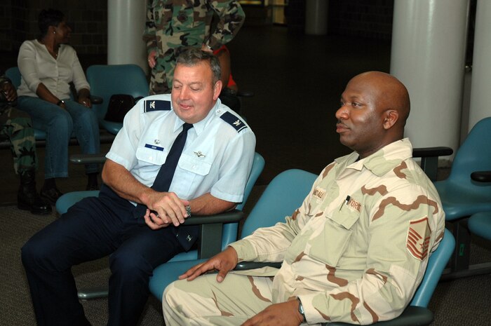 Master Sgt. Marvin Randall, an Air Force reservist assigned to the 38th Aerial Port Squadron, Charleston AFB, S.C., talks with Col. Gary Cook, commander of the 315th Airlift Wing, as he waits to leave for an extended deployment at the Charleston International Airport.  (Photo by 1st Lt. Wayne Capps, USAFR)