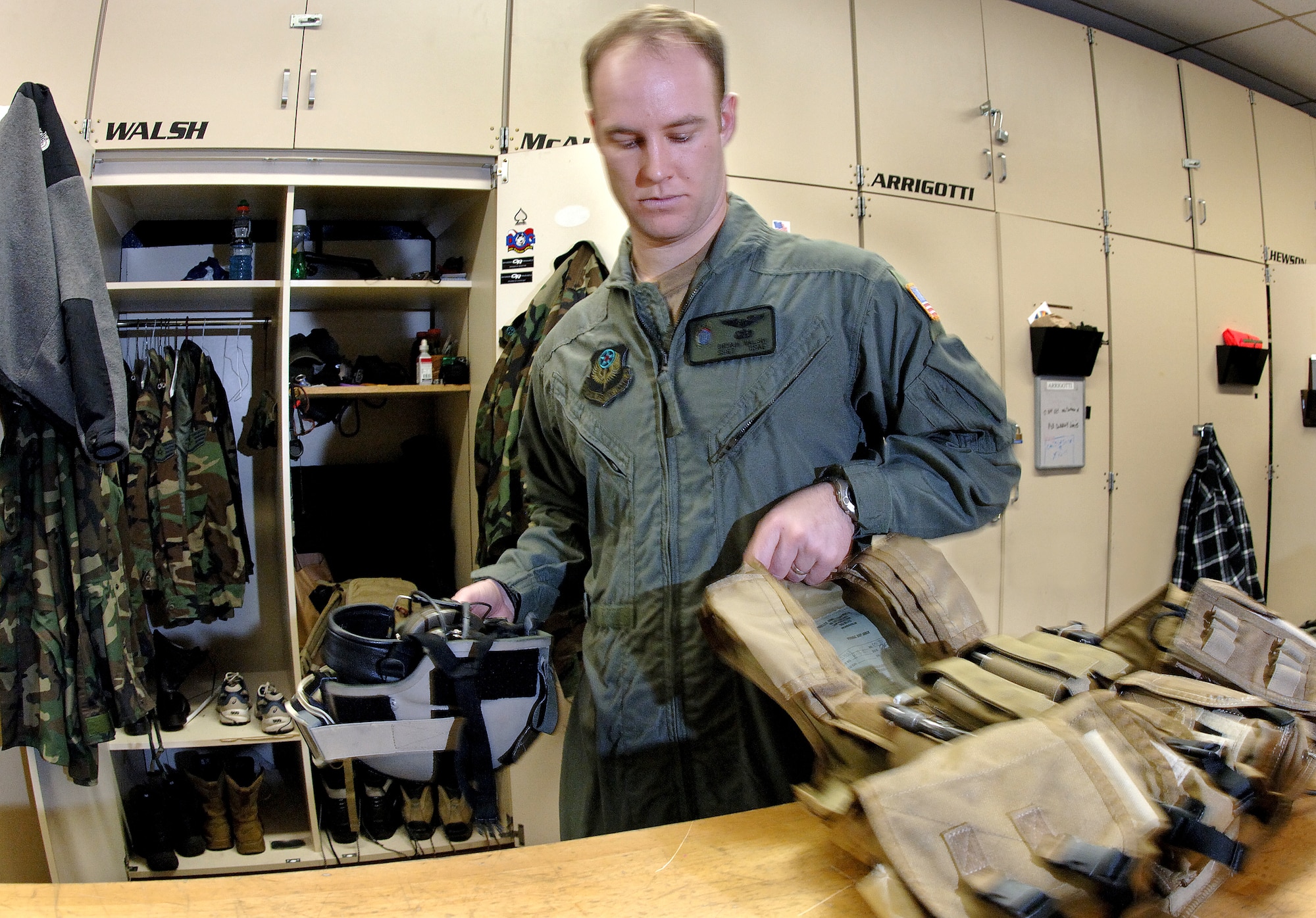 Staff Sgt. Bryan Walsh puts away his load-bearing vest and helmet after a mission.  Sergeant Walsh is a pararescueman with the New York Air National Guard's 103rd Rescue Squadron. (U.S. Air Force photo/Master Sgt Jack Braden)