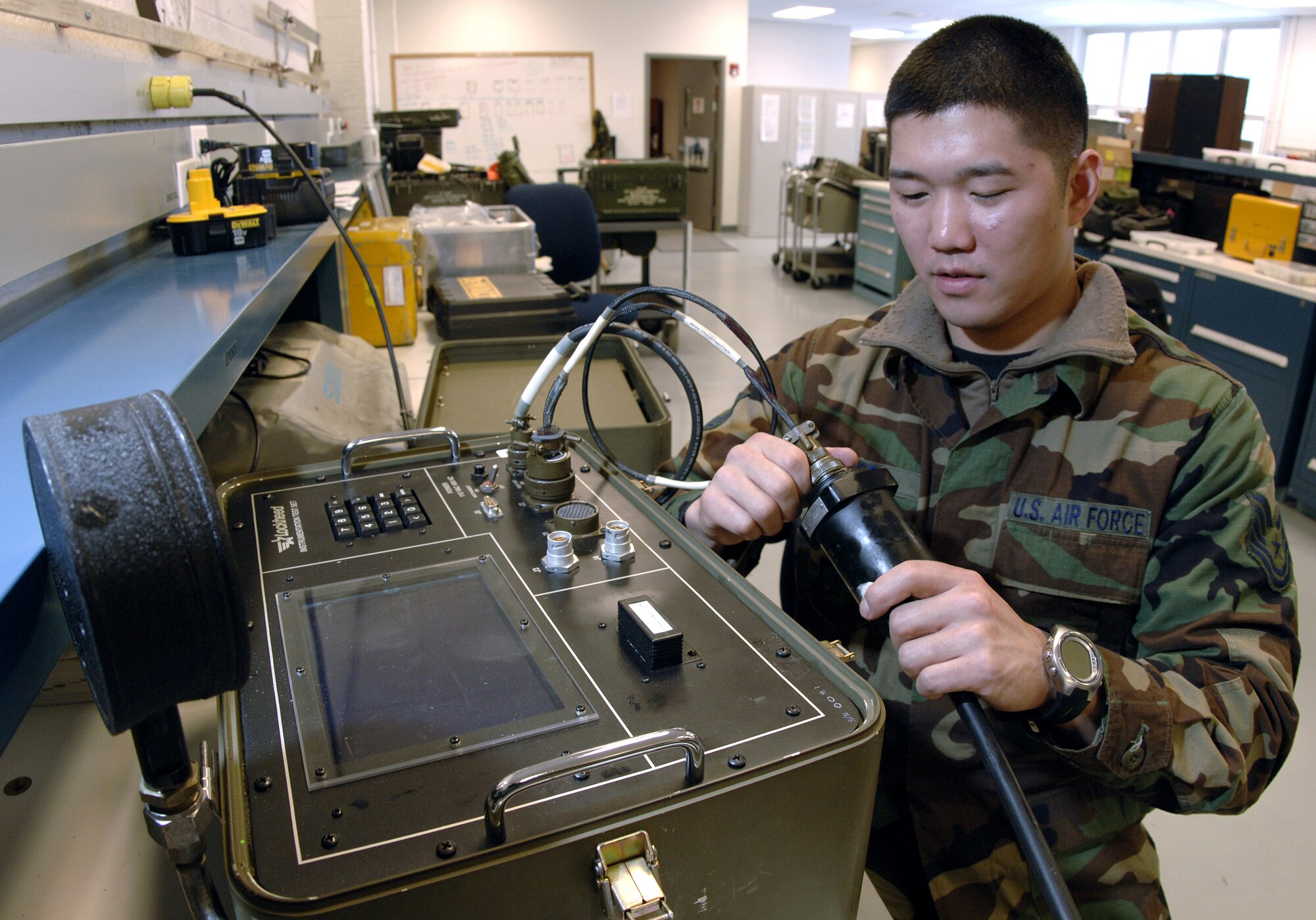 Tech. Sgt. James Lee connects an oil pressure transmitter to a bench tester.  The transmitter sends oil pressure readings to the cockpit of the HH-60 Pave Hawk.  Sergeant Lee is a guidance and controls systems specialist with the New York Air National Guard's 106th Maintenance Squadron. (U.S. Air Force photo/Master Sgt Jack Braden)